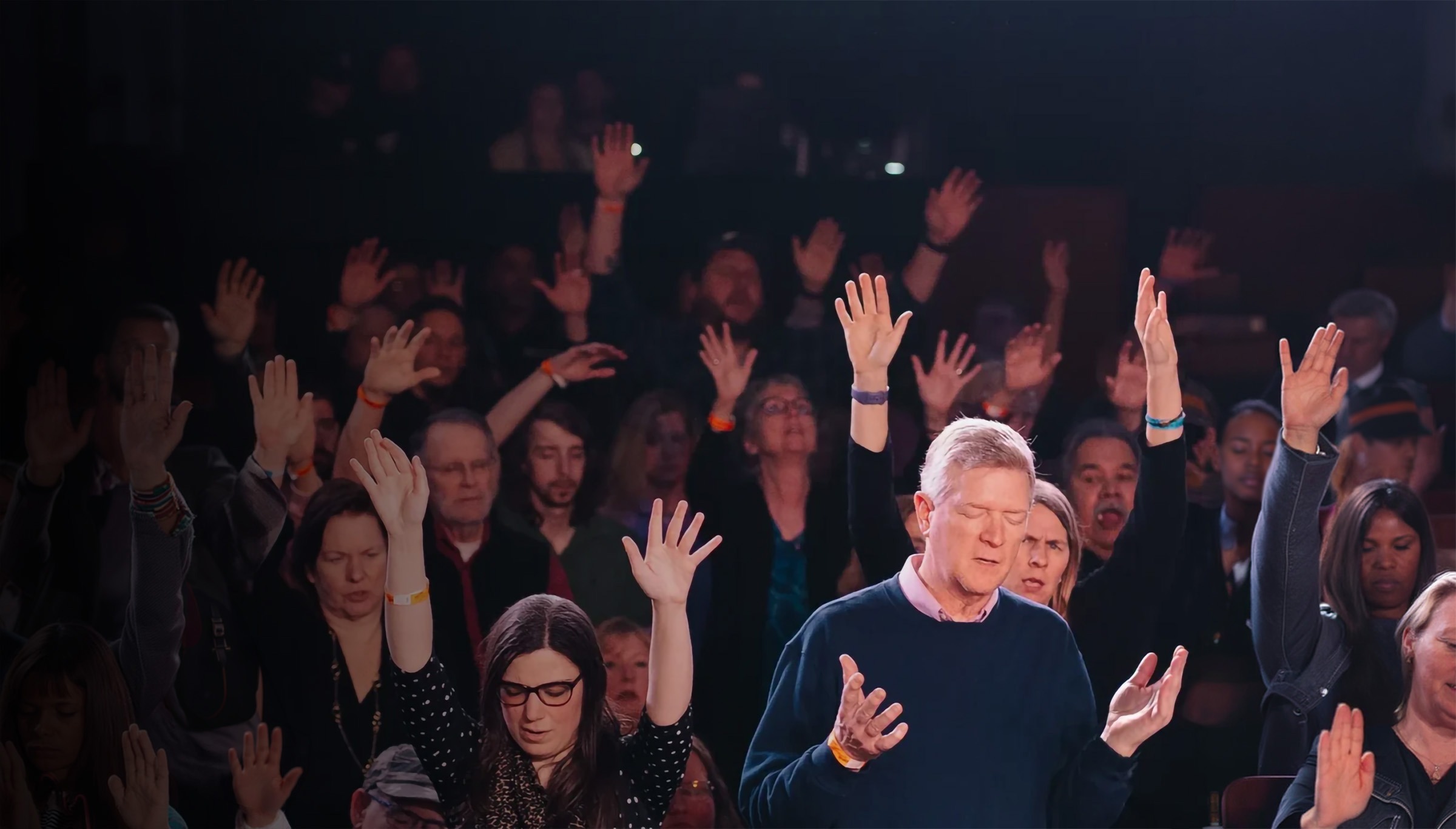 Congregation with hands raised in worship